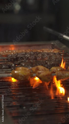 Grilling delicious kebabs over open flames food preparation area culinary art vibrant kitchen environment close-up perspective flavorful cooking concept