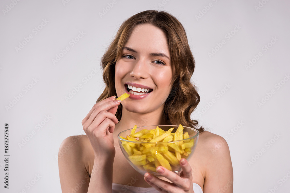 Girl is posing with bowl of fries isolated. Girl is posing with bowl of fries isolated.