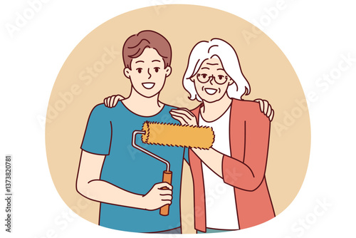 Grandmother hugging grandson doing repairs and using roller to paint walls in apartment and renovate interior. Elderly gray-haired woman near young happy man ready to start repairs in house