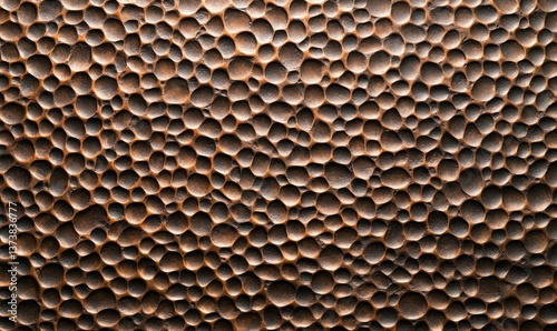 Detailed hammered copper texture exhibits a captivating pattern, perfect for backgrounds and designs.