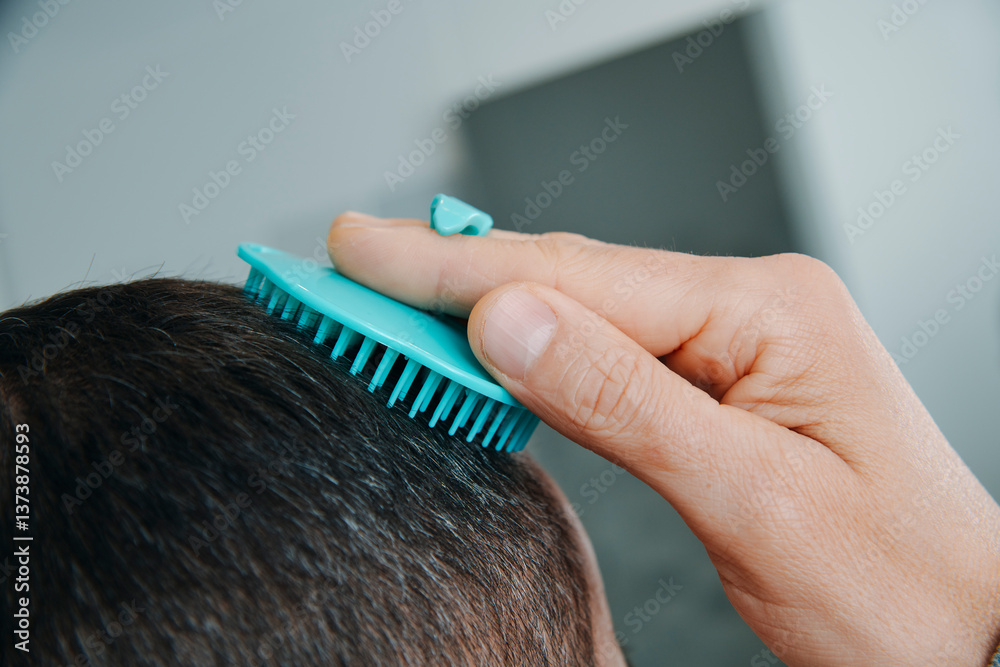 man in the bathroom combing his hair
