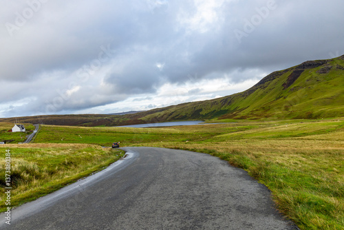 Winding roads cut through the natural wonders of the Isle of Skye: cliffs, rugged coastlines, and green hills shape a unique journey through wild beauty and unforgettable views.
