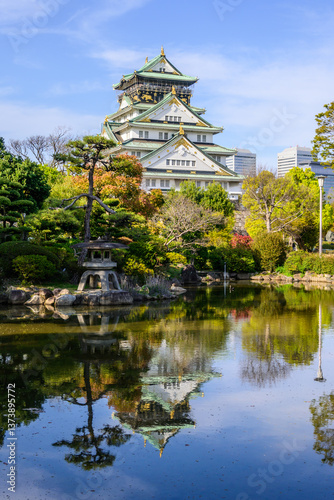Canvas Print Osaka Castle, rebuilt in 16th century, reflects in a serene pond