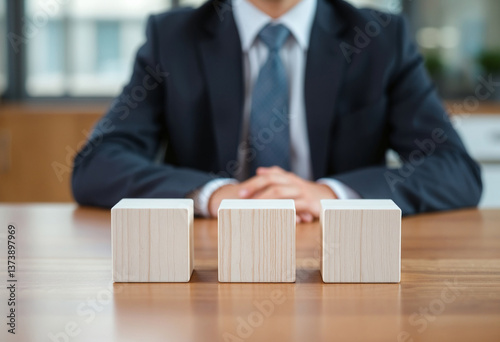 There are three wooden cubes lined up.
Wooden Blocks and Business Decision-Making.