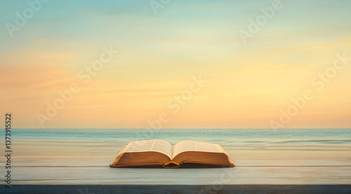 Fototapeta Naklejka Na Ścianę i Meble -  An open Bible on a wooden table with the sea and the sea at sunset