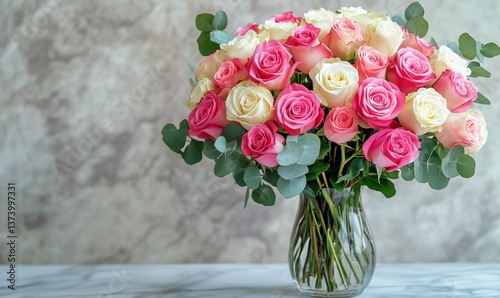 Beautiful Bouquet of Pink and White Roses Arranged in a Glass Vase on a Marbl...