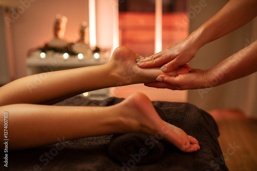 Wallpaper Mural Professional therapist doing foot massage on female client, working in serene spa salon with warm candles lighting designed for relaxation Torontodigital.ca