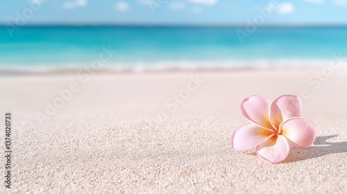 Single pink plumeria flower resting on soft sand with a turquoise ocean and sky in the background. Evokes tropical peace and is perfect for travel, wellness, and summer design projects photo