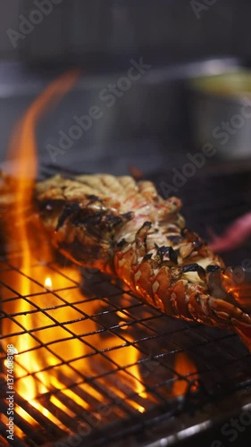 Grilling lobster tail over flames outdoor kitchen culinary art gourmet experience close-up view seafood delight for summer feasts