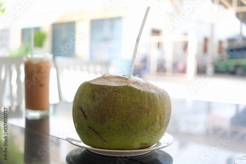 Tropical Refreshment : Fresh Coconut Drink on a Cafe Table