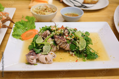 Steamed squid with lemon and spicy thai squid salad with lime and herbs