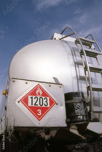 Flammable hazmat sticker on fuel tanker trailer.