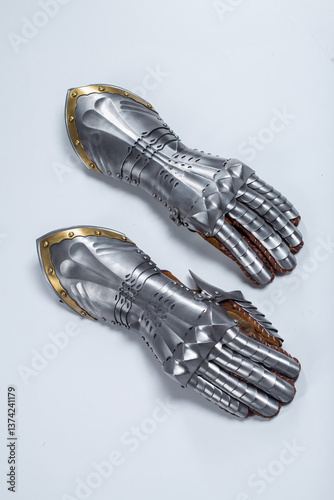 Canvastavla Pair of steel knight gauntlets with golden accents