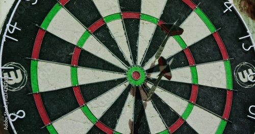 darts hitting in center of dartboard