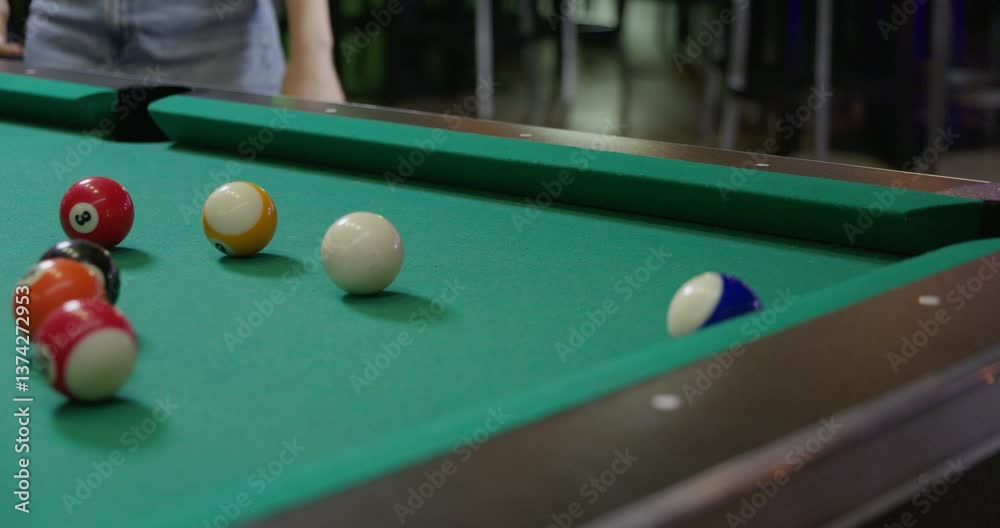 billiards ball getting knocked into pocket