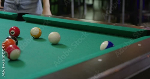 billiards ball getting knocked into pocket