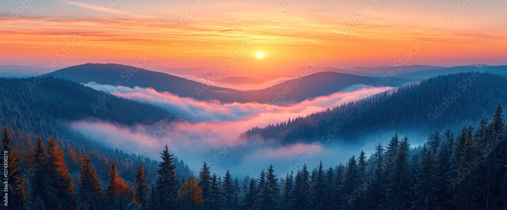 Obraz premium Sunrise over misty mountain peaks