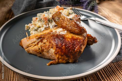 Roast chicken served with russian traditional salad.