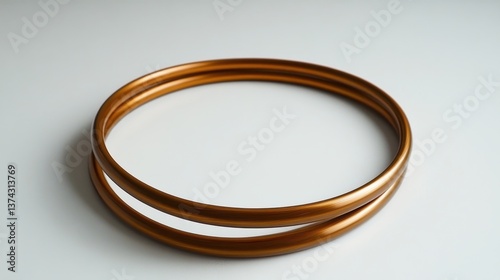 Wallpaper Mural Elegant bronze rings on a clean white surface creating a modern aesthetic perfect for jewelry design or abstract art projects showcasing simplicity Torontodigital.ca