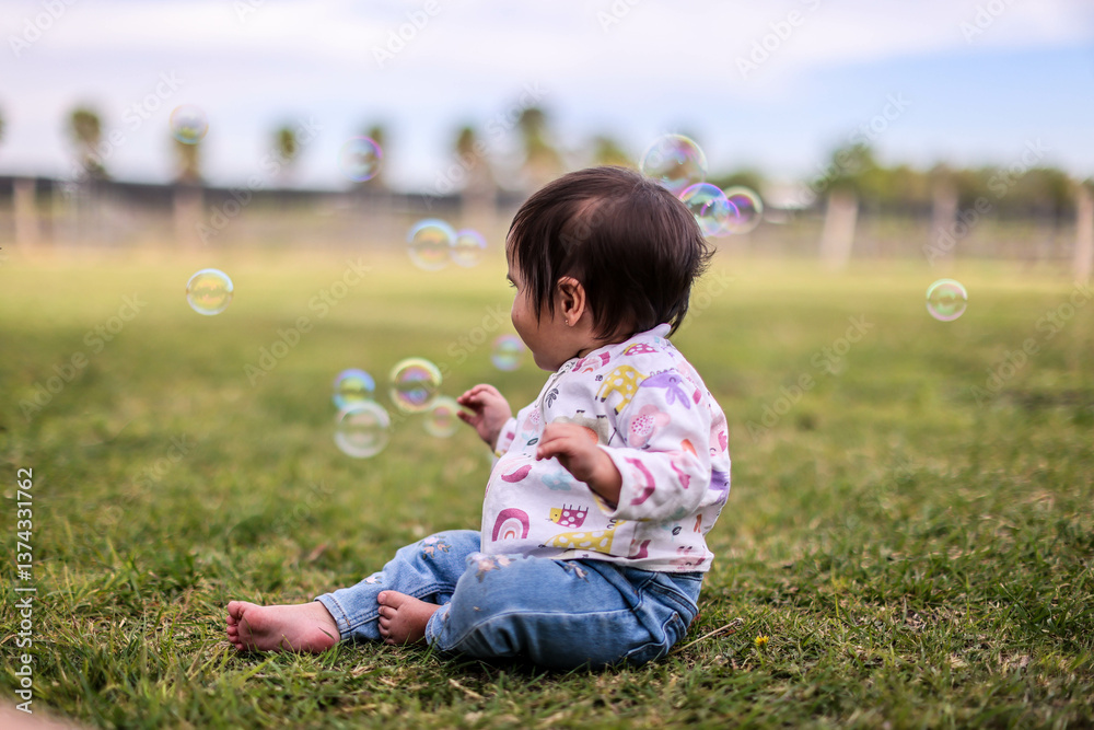 Outdoor portrait of a cute baby girl playing in garden Outdoor portrait of a cute baby girl playing in garden