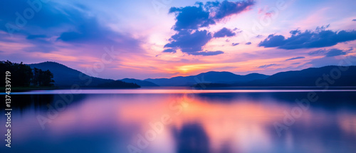 tranquil lake scene at s et showcases vibrant colors reflecting on water, surrounded by mountains and serene sky. peaceful atmosphere invites relaxation and contemplation
