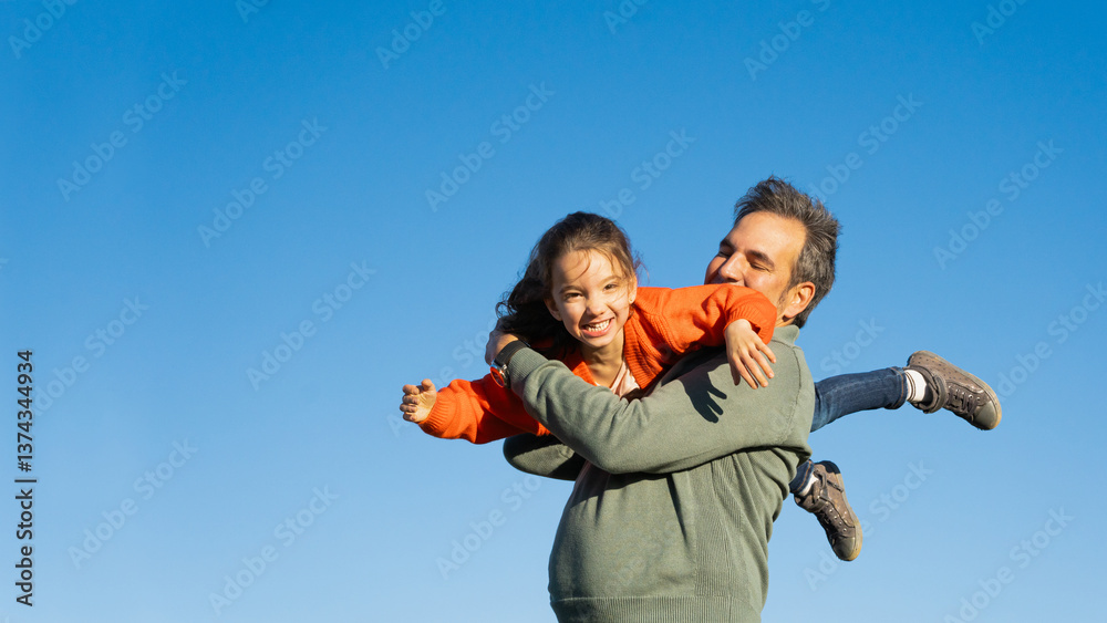 Happy father lifting daughter in the air against blue sky. Happy father lifting daughter in the air against blue sky.