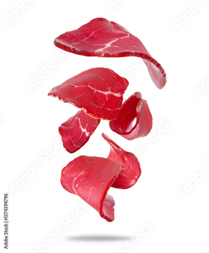 Thinly sliced ​​venison in the air close-up isolated on white background photo