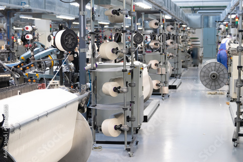 Industrial fabric production line. Looms in a textile factory