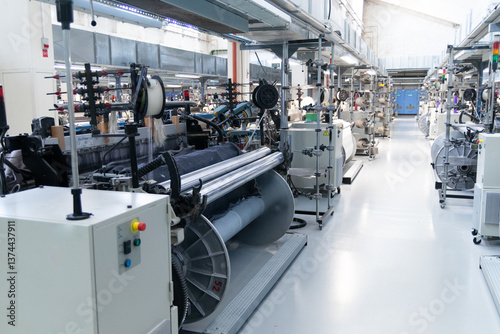 Industrial fabric production line. Looms in a textile factory