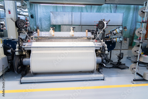 Industrial fabric production line. Looms in a textile factory