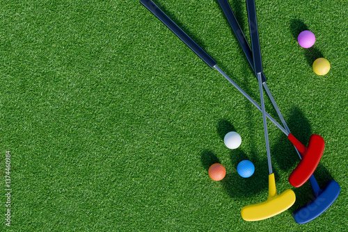 Mini golf clubs and sports balls on green grass.3D rendering