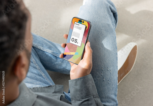 Smartphone Screen Held by Seated Person. PSD mockup