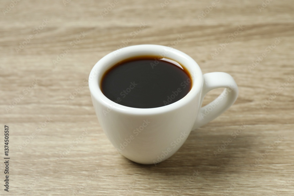 Cup of coffee with coffee beans on wooden background Cup of coffee with coffee beans on wooden background