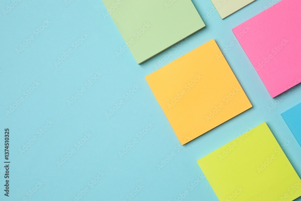 Multicolored paper stickers on a pink background