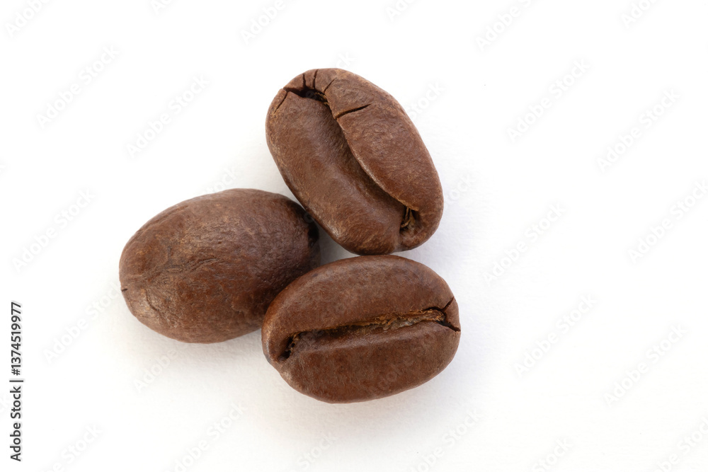 Close-Up Photograph of Three Coffee Beans on White Background