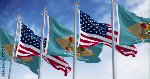 Fotografie Delaware and US flags waving together in the sky, symbol of American unity