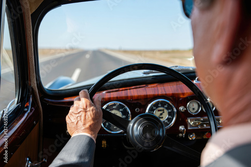Elderly caucasian male driving classic car on open road