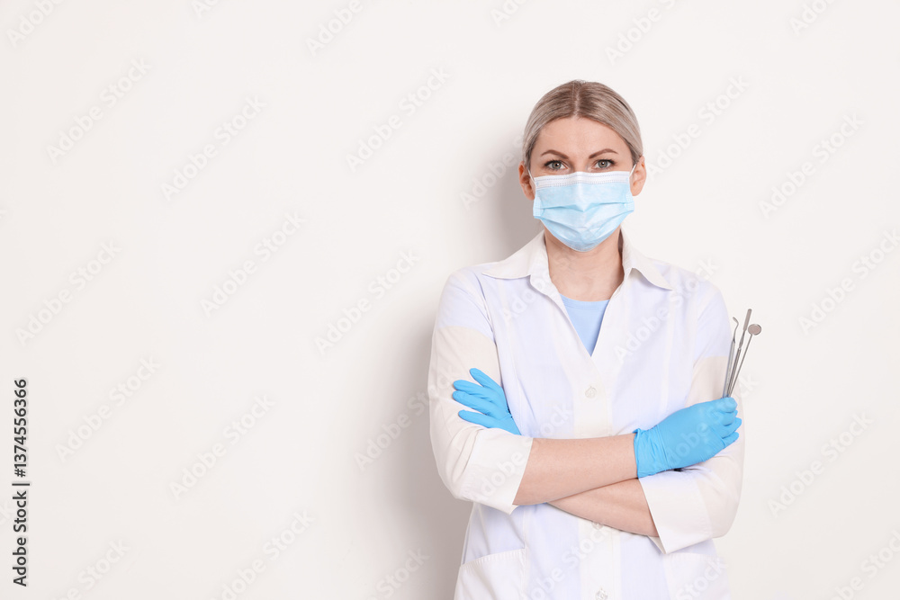 Professional dentist with tools on white background. Space for text Professional dentist with tools on white background. Space for text
