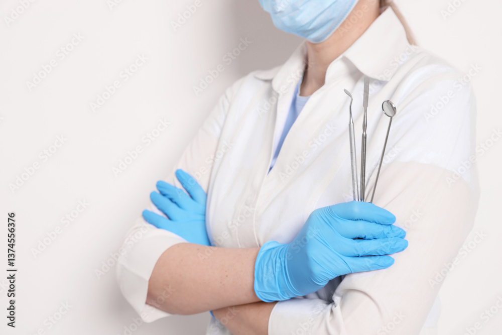 Professional dentist with tools on white background, closeup Professional dentist with tools on white background, closeup