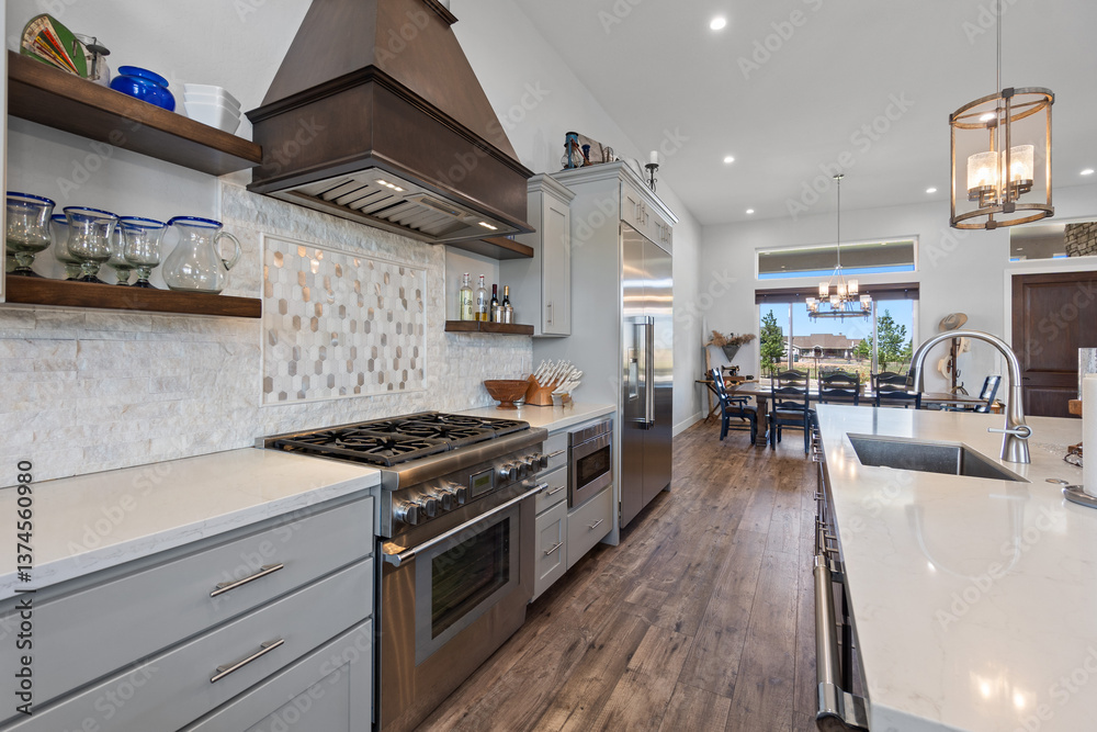 Fototapeta premium A spacious kitchen featuring a large island and nicely designed wooden chairs