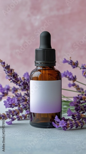 Lavender Essential Oil Bottle Surrounded by Fresh Lavender Flowers on a Paste...