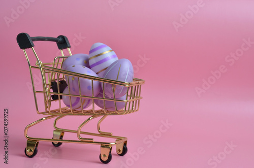 Easter eggs of purple color in a shopping basket on a pink background.