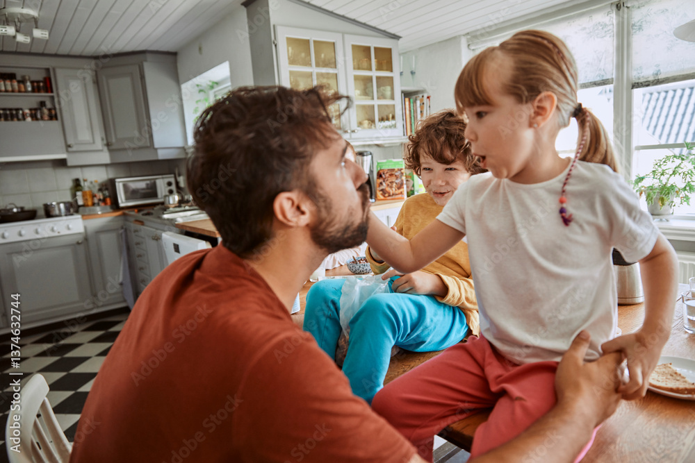 Fototapeta premium Single father having breakfast with his kids in the morning in the kitchen