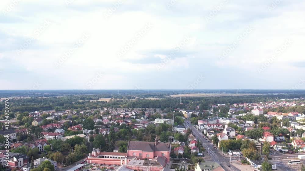 Drone ascending on urban cityscape with trees around houses and busy street Drone ascending on urban cityscape with trees around houses and busy street