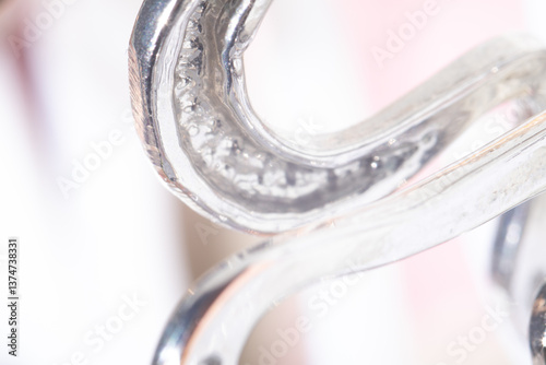 Luxury metal background. Bright and luminous macro shot capturing the reflective beauty of silver decor. Aesthetic blurred background with soft focus in high key