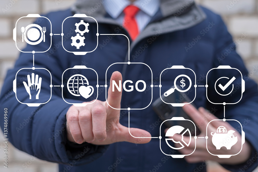 Business person or politician using virtual touch screen push abbreviation: NGO. NGO Non Governmental Organization Contribution Corporate Foundation Nonprofit Concept.