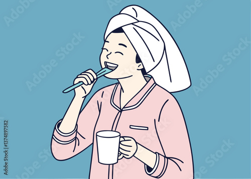 Asian woman in pink pajamas brushing her teeth while holding a white mug, with a towel wrapped on her head, smiling in front of a solid blue background, showing fun morning hygiene routine