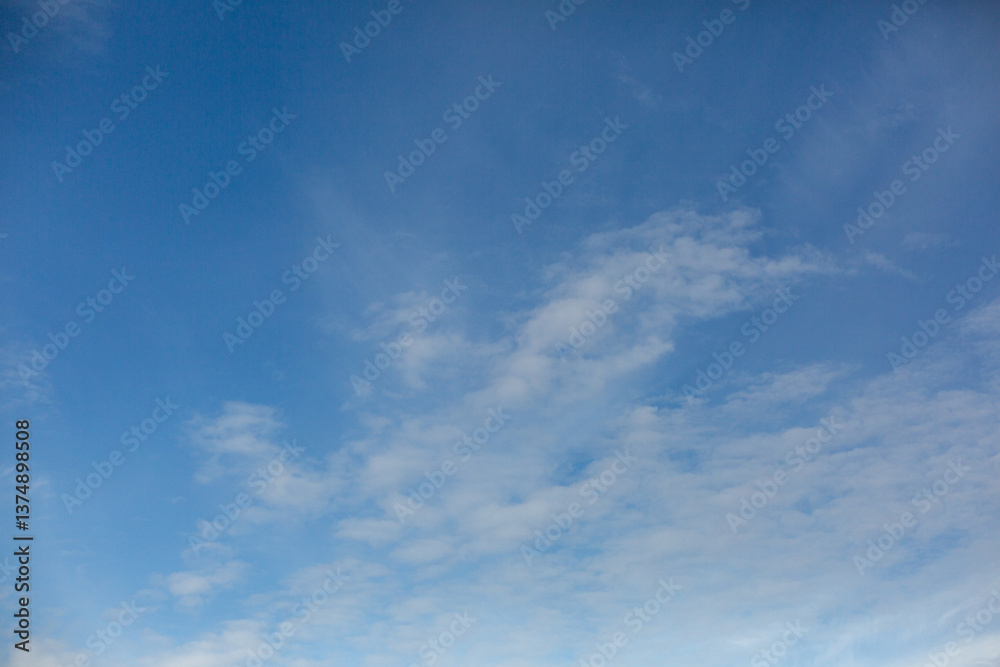 Fototapeta premium Clear Evening Sky With Soft Whispy Clouds and Deep Blue Background