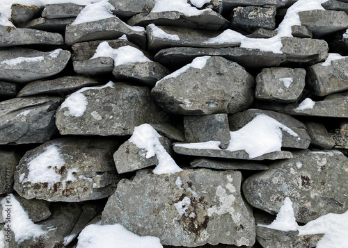 Stone Wall Background of Granite Rocks Stacked in a Pennsylvania Rural Area on a Snow Day