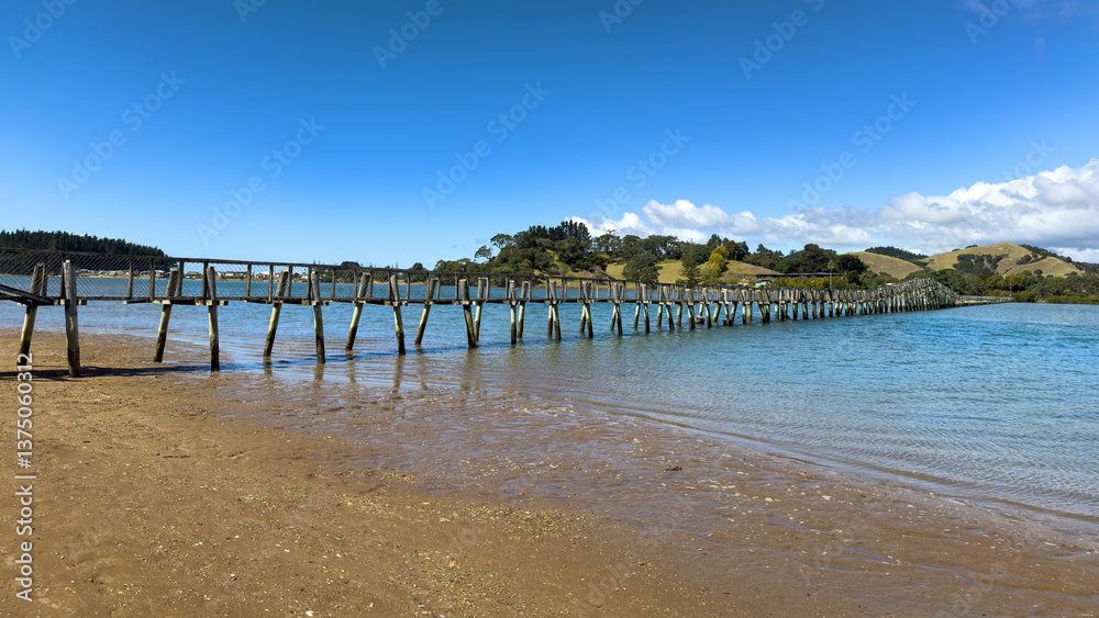 Fototapeta premium Southern Hemisphere's longest footbridge at Whananaki, Northland, New Zealand. 395 metres (1,296 feet) long, spanning the Whananaki Estuary. Built in 1947. Part of the Te Araroa Trail.